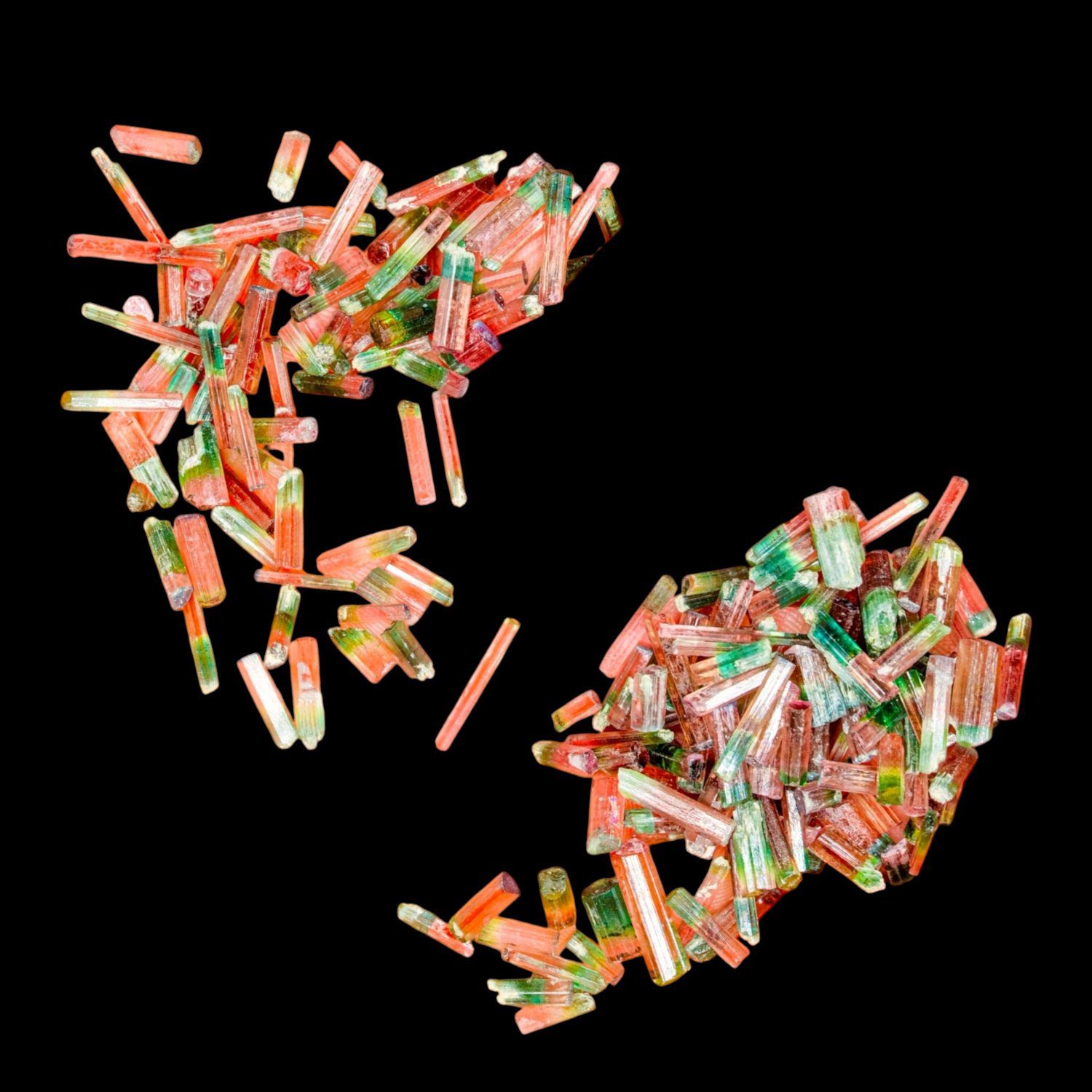 The Morro Redondo tourmaline parcel spread against a black background, showing the range of crystal sizes and colour zoning.